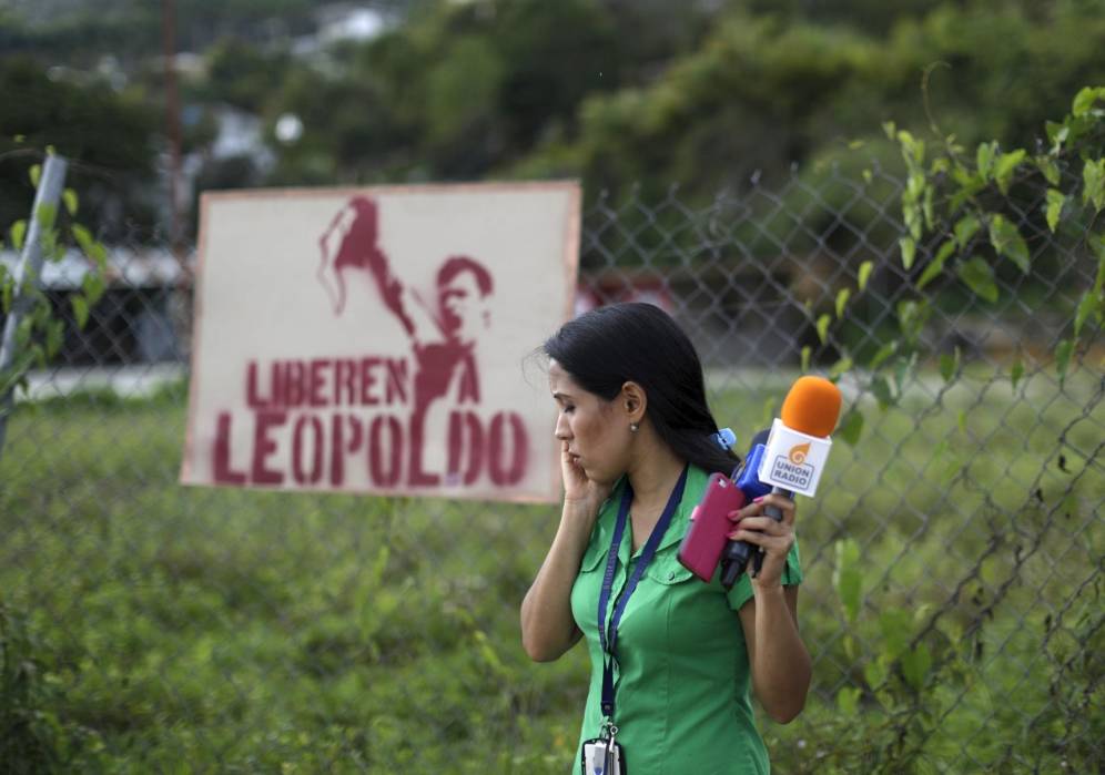 Una periodista frente a la prisión de Ramo Verde, donde está encarcelado el líder opositor Leopoldo López, en junio de 2015 (Reuters)